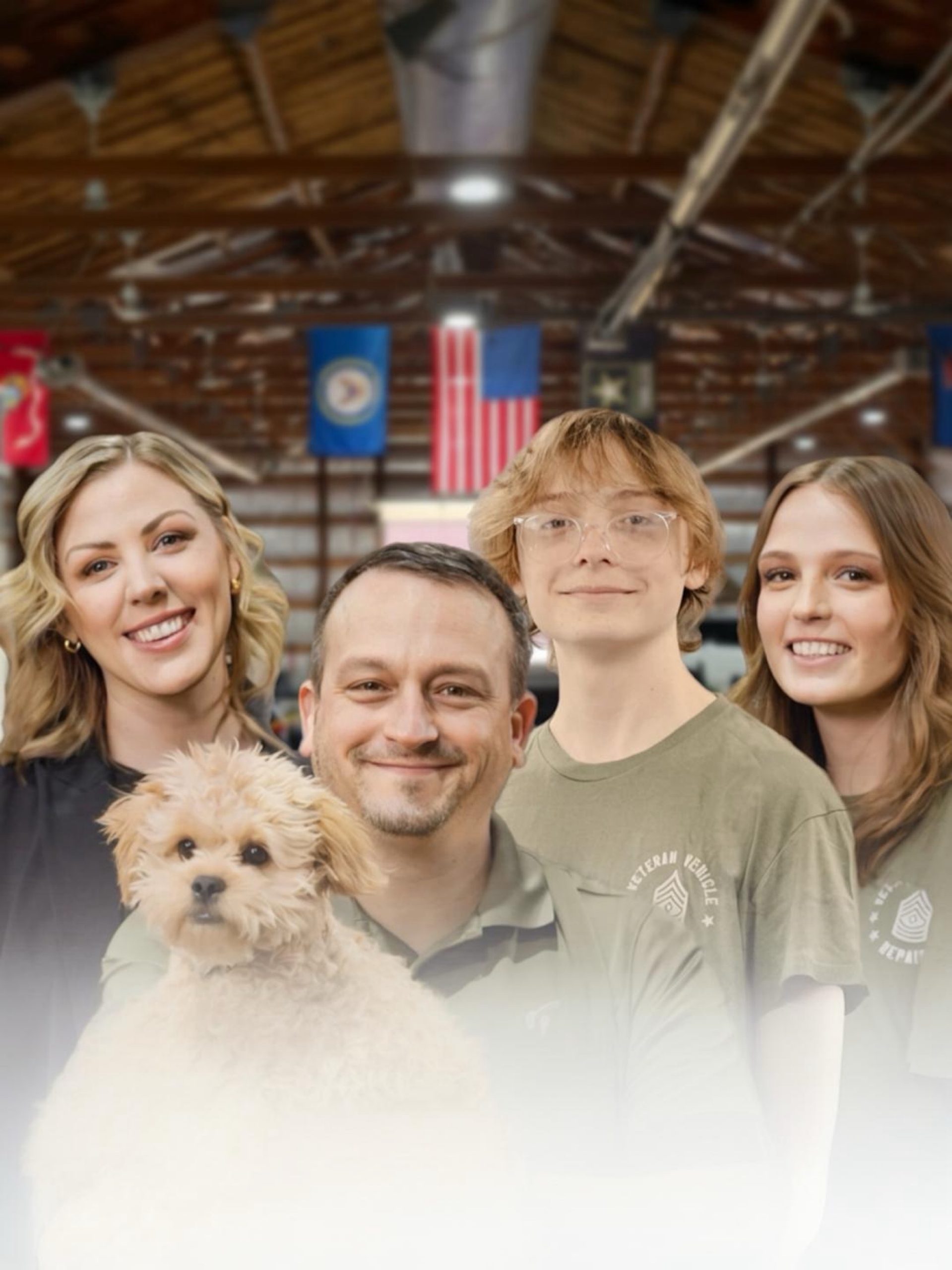 The Hayes family — Mike, Jen, and Bella — inside the VVR shop with military flags overhead